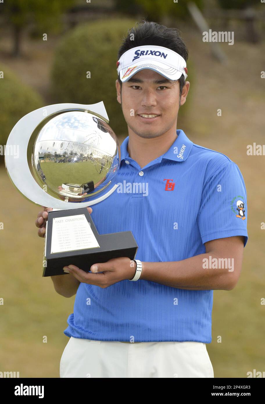Japan's Hideki Matsuyama poses with his trophy for photos after winning the  Casio World Open golf tournament at Kochi Kuroshio Country Club in Kochi,  western Japan, Sunday, Dec, 1, 2013. Matsuyama, 21,