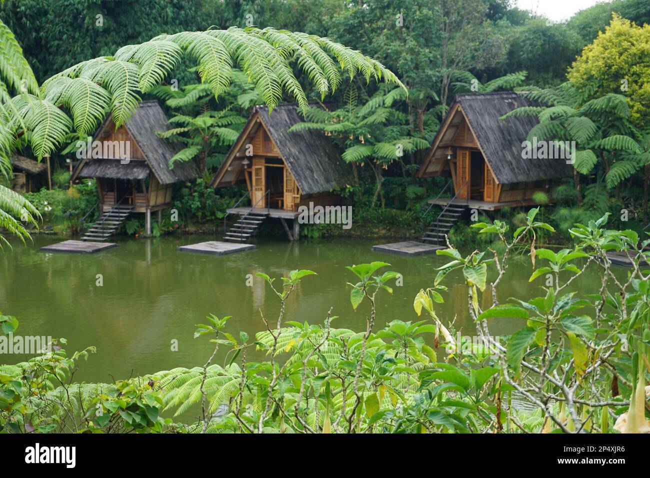 Bandung, Indonesia - February, 2023 : Panorama of a lake surrounded by wooden houses with boats in Bamboo Village (Dusun Bambu) at Lembang, Bandung, I Stock Photo