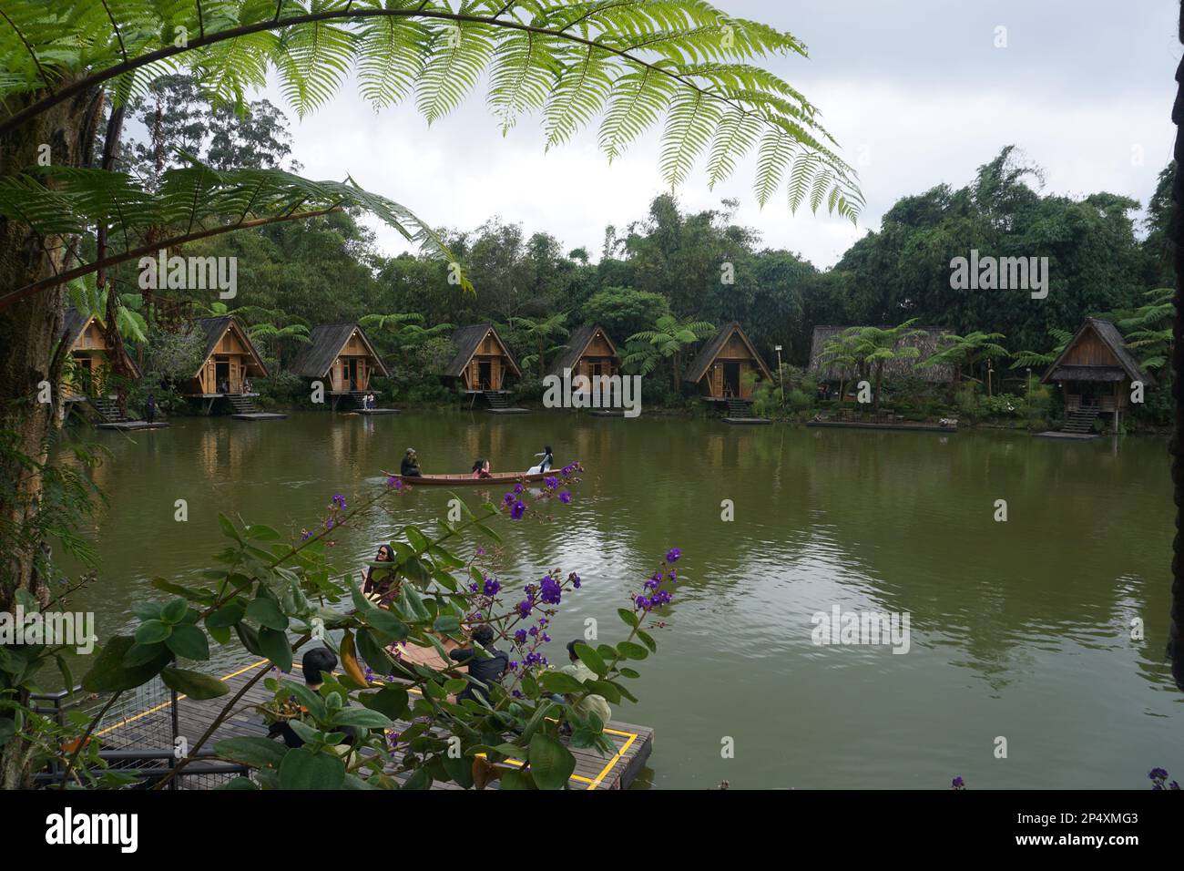 Bandung, Indonesia - February, 2023 : Panorama of a lake surrounded by wooden houses with boats in Bamboo Village (Dusun Bambu) at Lembang, Bandung, I Stock Photo