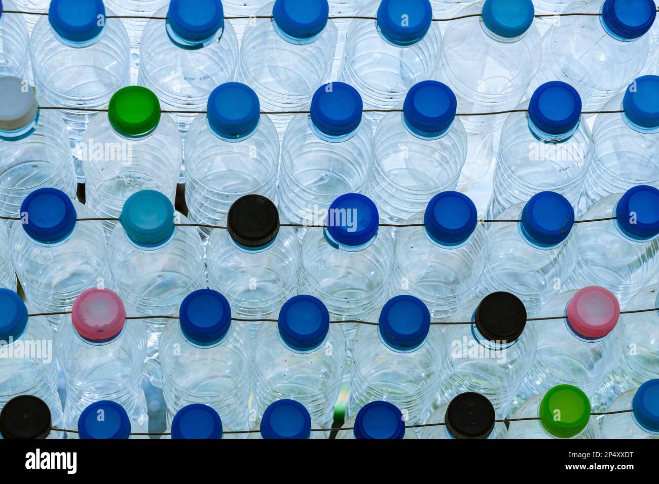 Beautiful wall made of multi colored recycled plastic bottles. Bottle