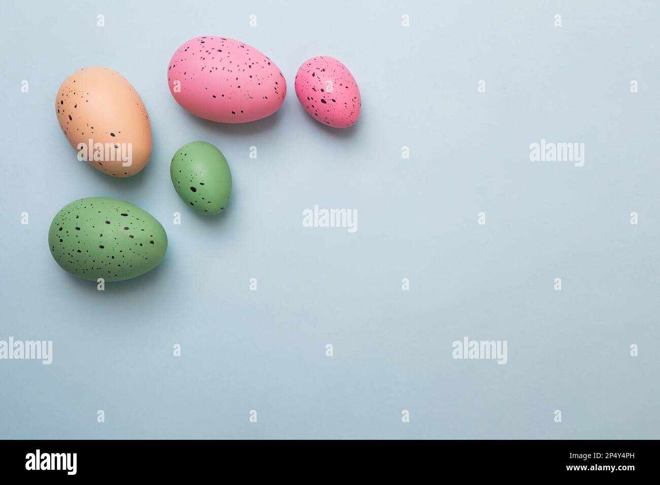 Frame from multicolored eggs on blue background.Easter concept. Stock Photo