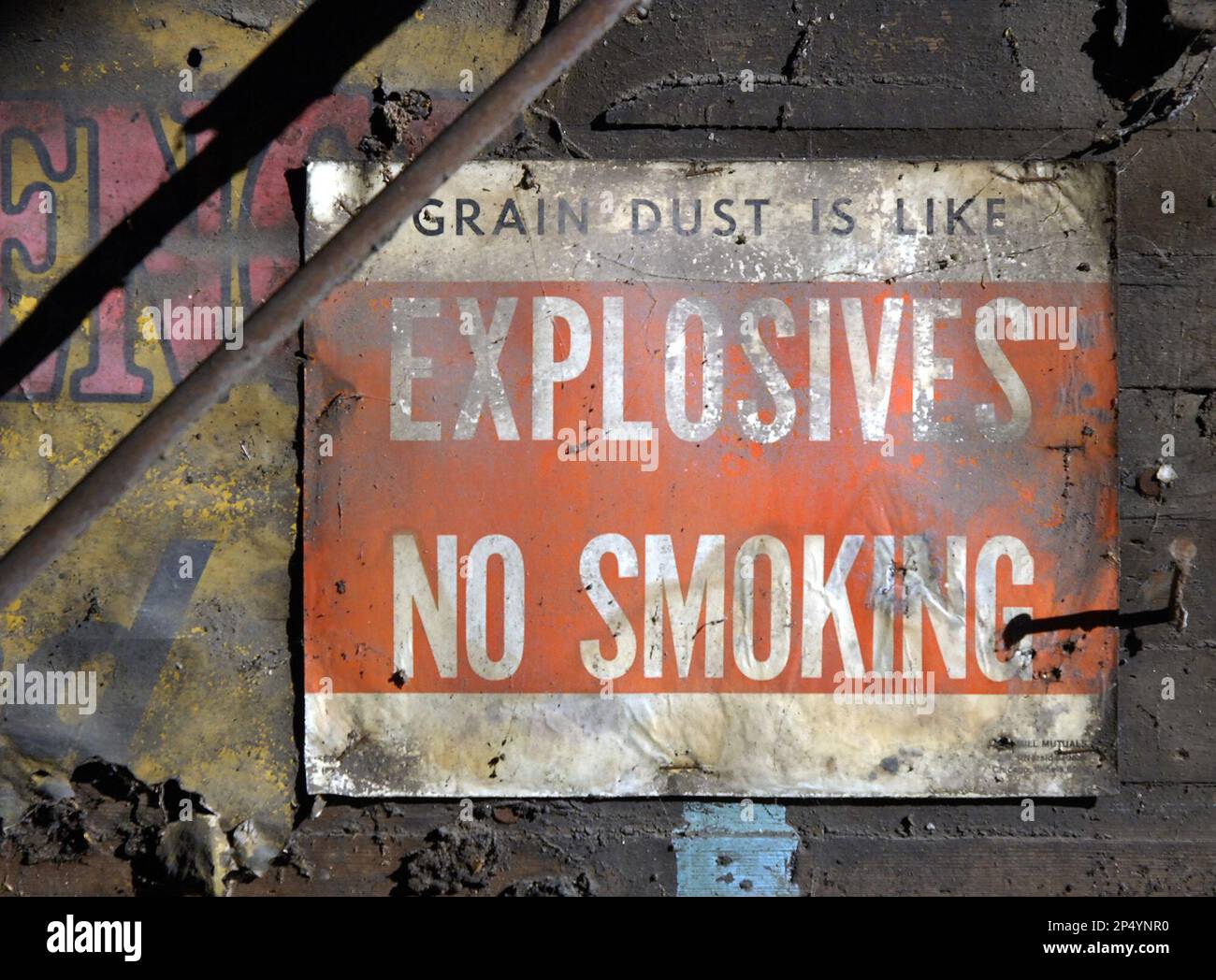 This photo shows a sign in a wood grain elevator that is being torn
