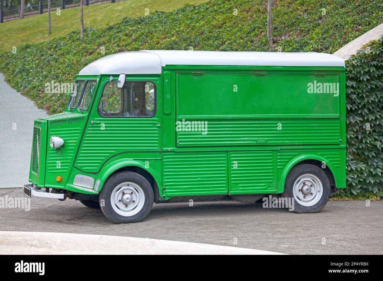 Paris, France - June 22 2018: Left side view of a Green Citroen H Van pre-1969 model with semi-circular rear wings and suicide doors. Stock Photo