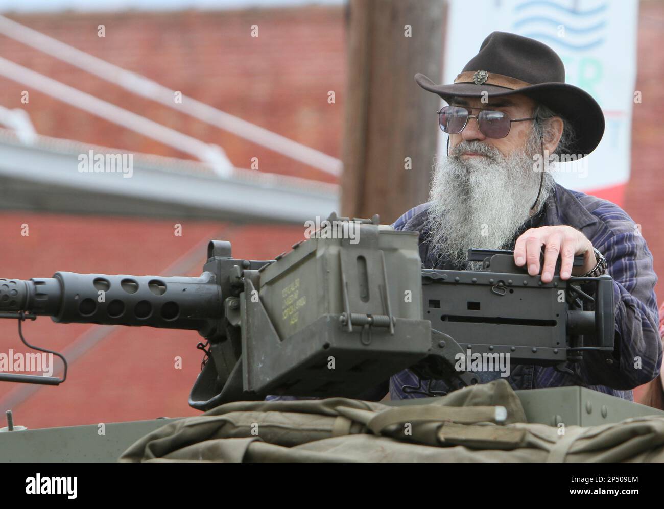 Vietnam veteran and Grand Marshal "Uncle Si" Robertson from A&E's hit television 'Duck Dynasty' rides next to a .50 caliber machine gun atop a half-track in the Veterans Day Parade hosted