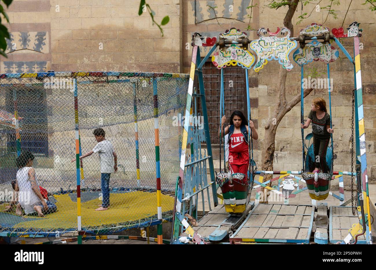 EGYPT, Cairo, old town, playground, children on swing Stock Photo Alamy