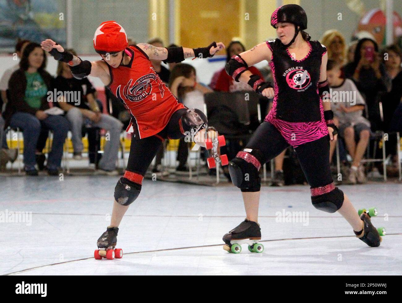 ADVANCE FOR MONDAY, NOVEMBER 4, 2013 AND THEREAFTER - In this photo taken  Oct. 19, 2013, Danika "Fearce" McCall, left, of the Mississippi  Rollergirls, shows incredible balance as she skates on one