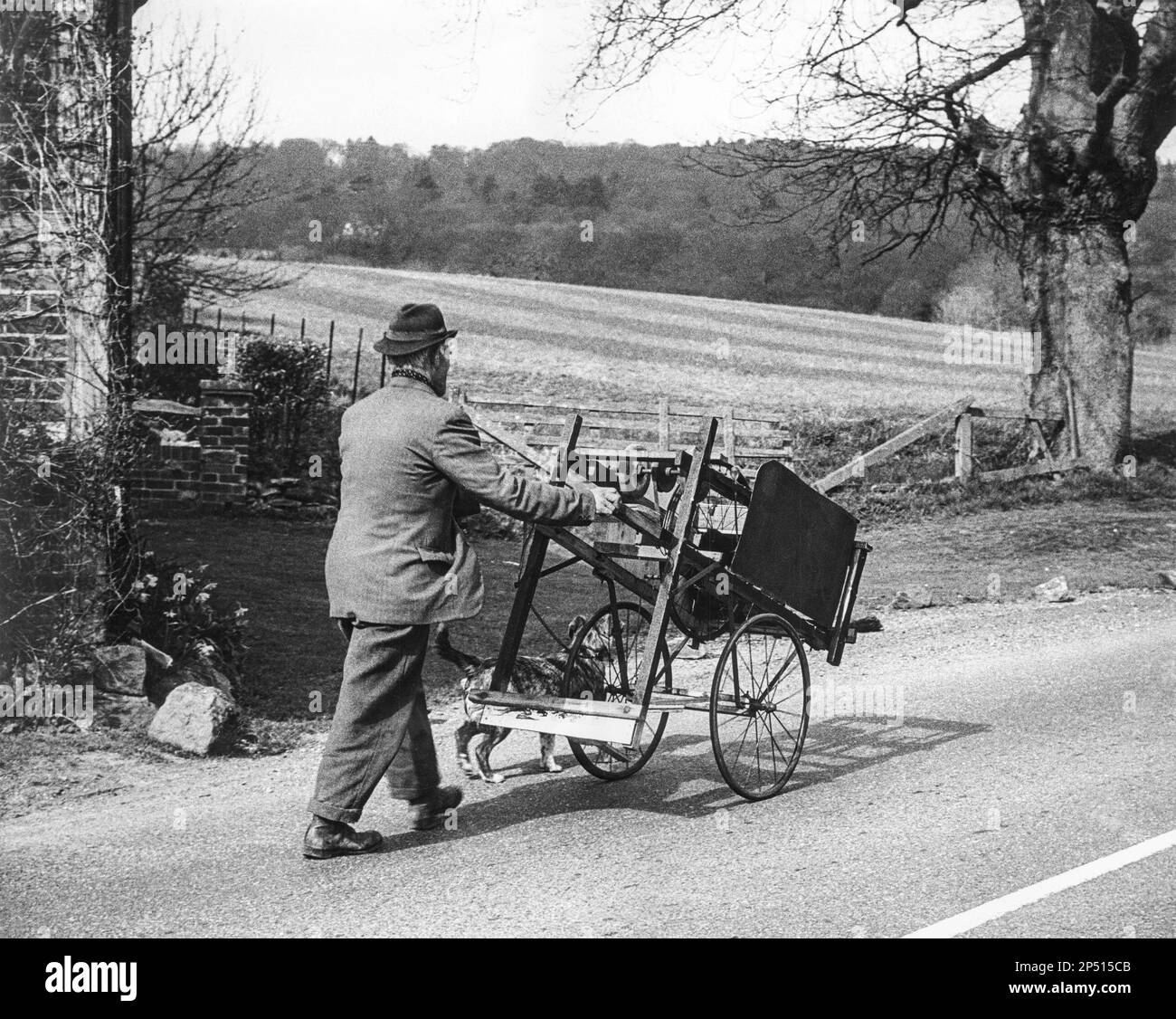 An itinerant knife grinder and his dog in a lane in Surrey, England UK taken (I think) in 1970. Stock Photo