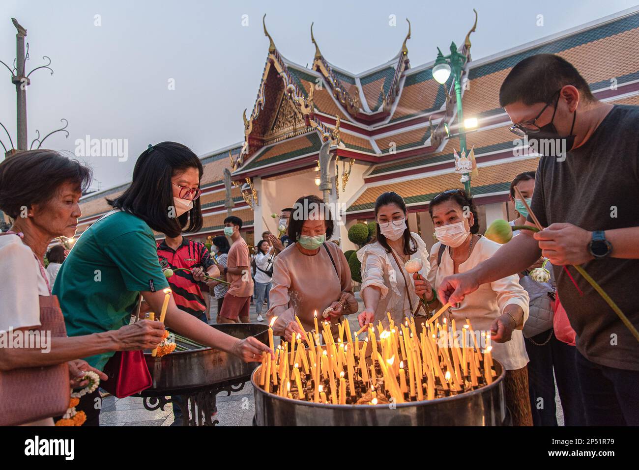 Bangkok, Thailand. 06th Mar, 2023. Thai Buddhist devotees light candles