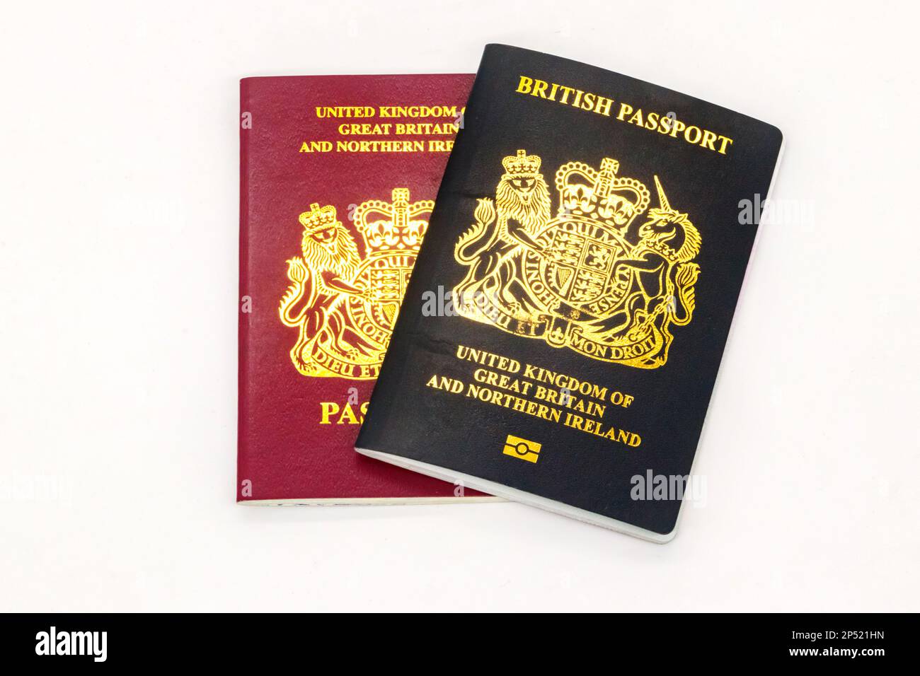 old and new UK British passports maroon and black blue Stock Photo