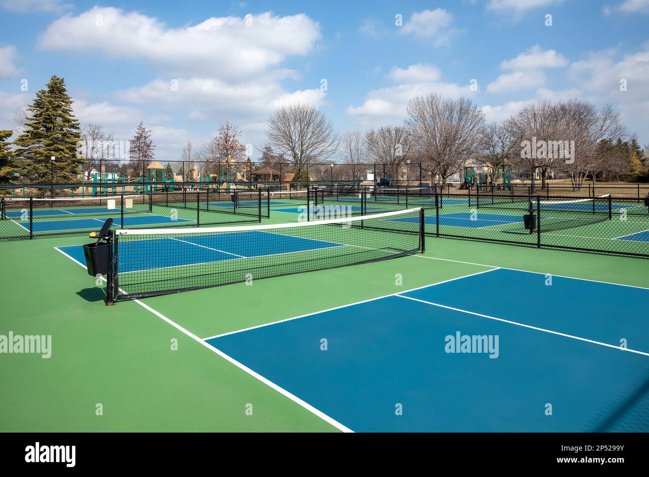 View of a pickleball complex with blue and green courts beside a