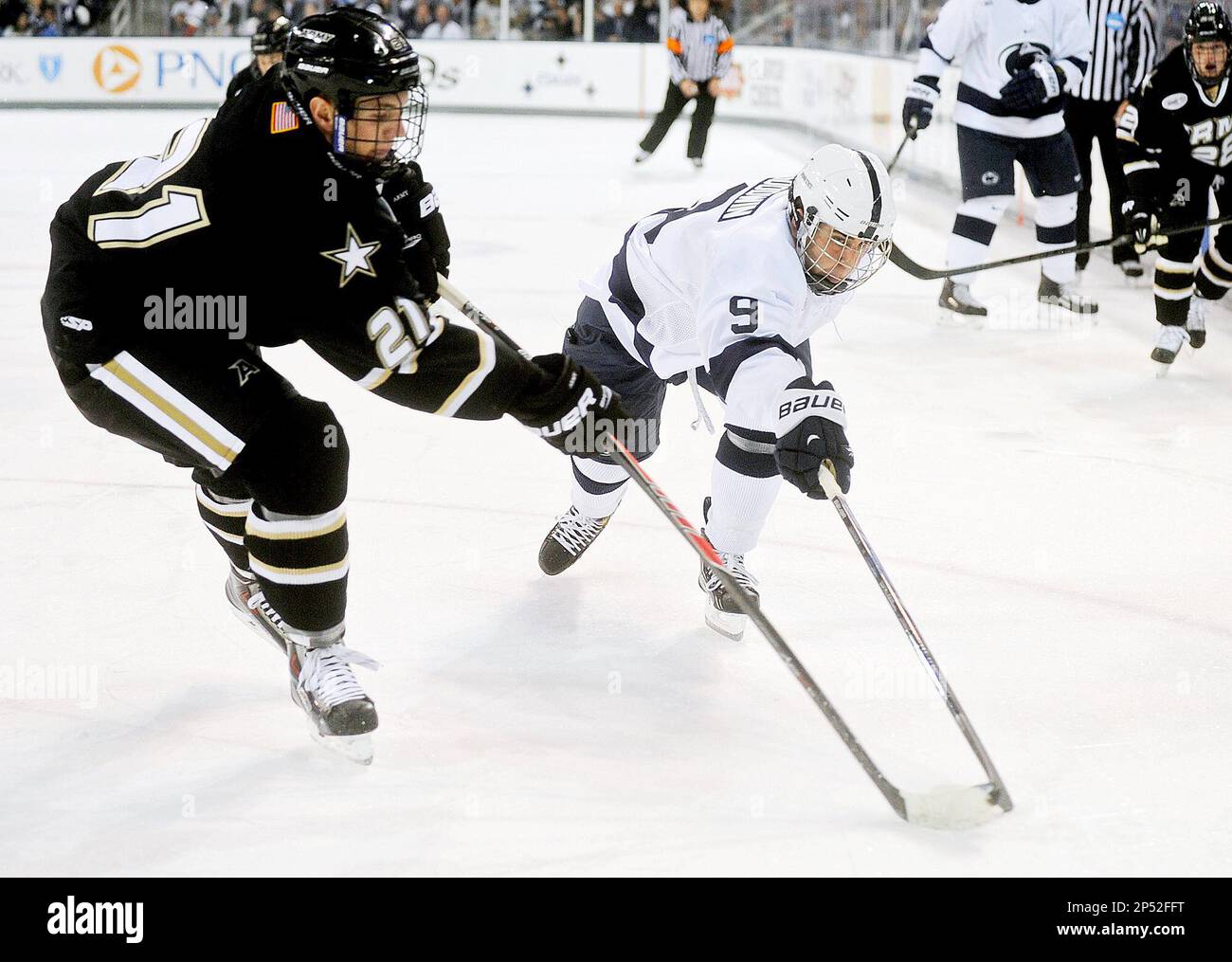 Armys Garret Peterson tries to stop Penn States David Goodwin during the Friday, October 11, 2013 opening game at Pegula Ice Arena