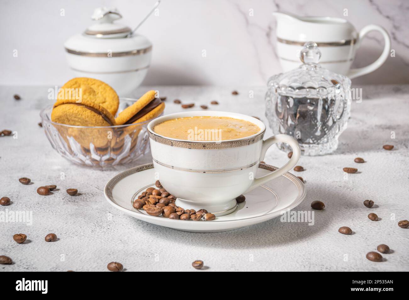Coffee cup,coffee beans and sweets on the background Stock Photo