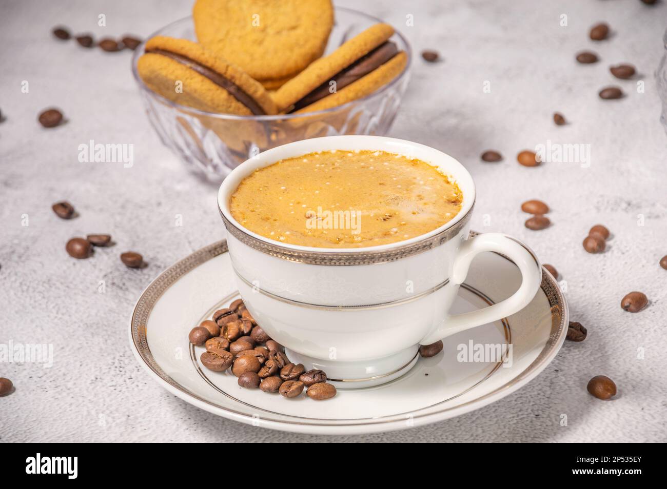 Coffee cup,coffee beans and sweets on the background Stock Photo