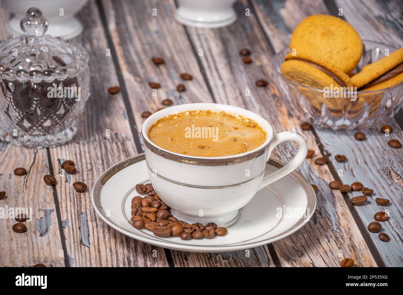 Coffee cup,coffee beans and sweets on the background Stock Photo
