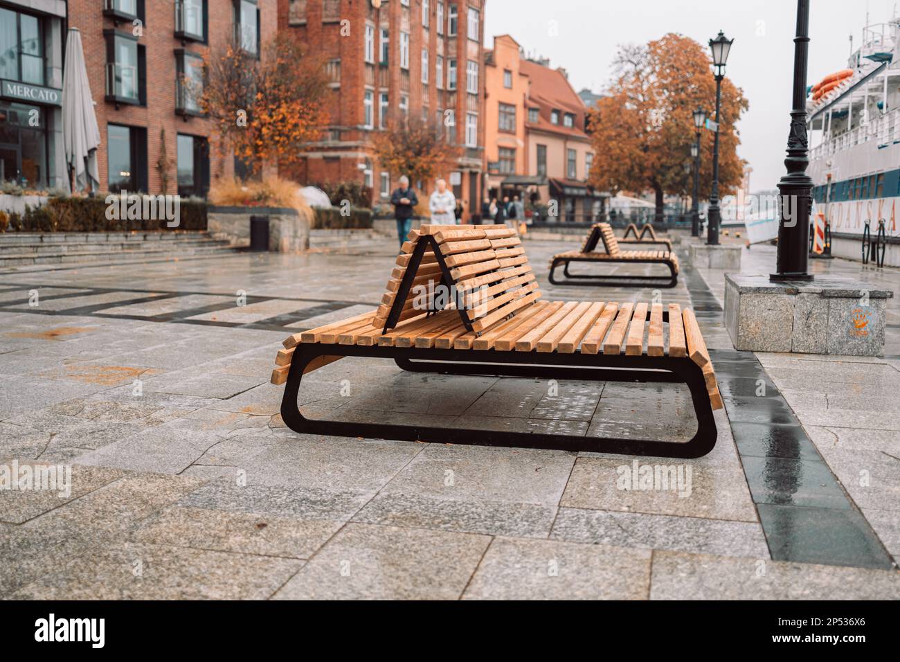 The cityscape with a modern wood benches on the sidewalk at Gdansk, Poland  Stock Photo - Alamy