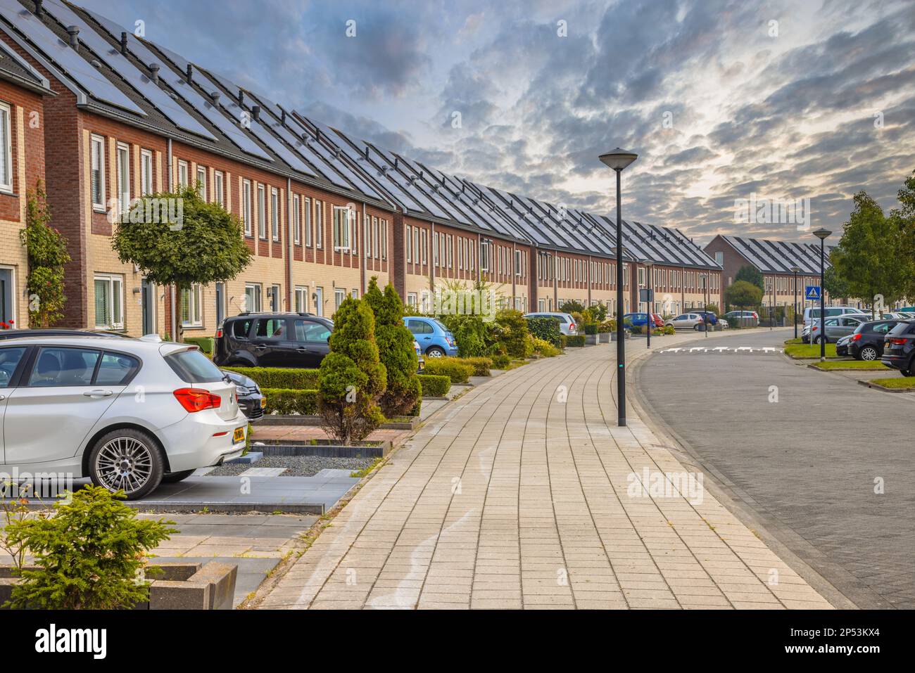 Row of modern houses in curved street. Contemporary neighborhood with