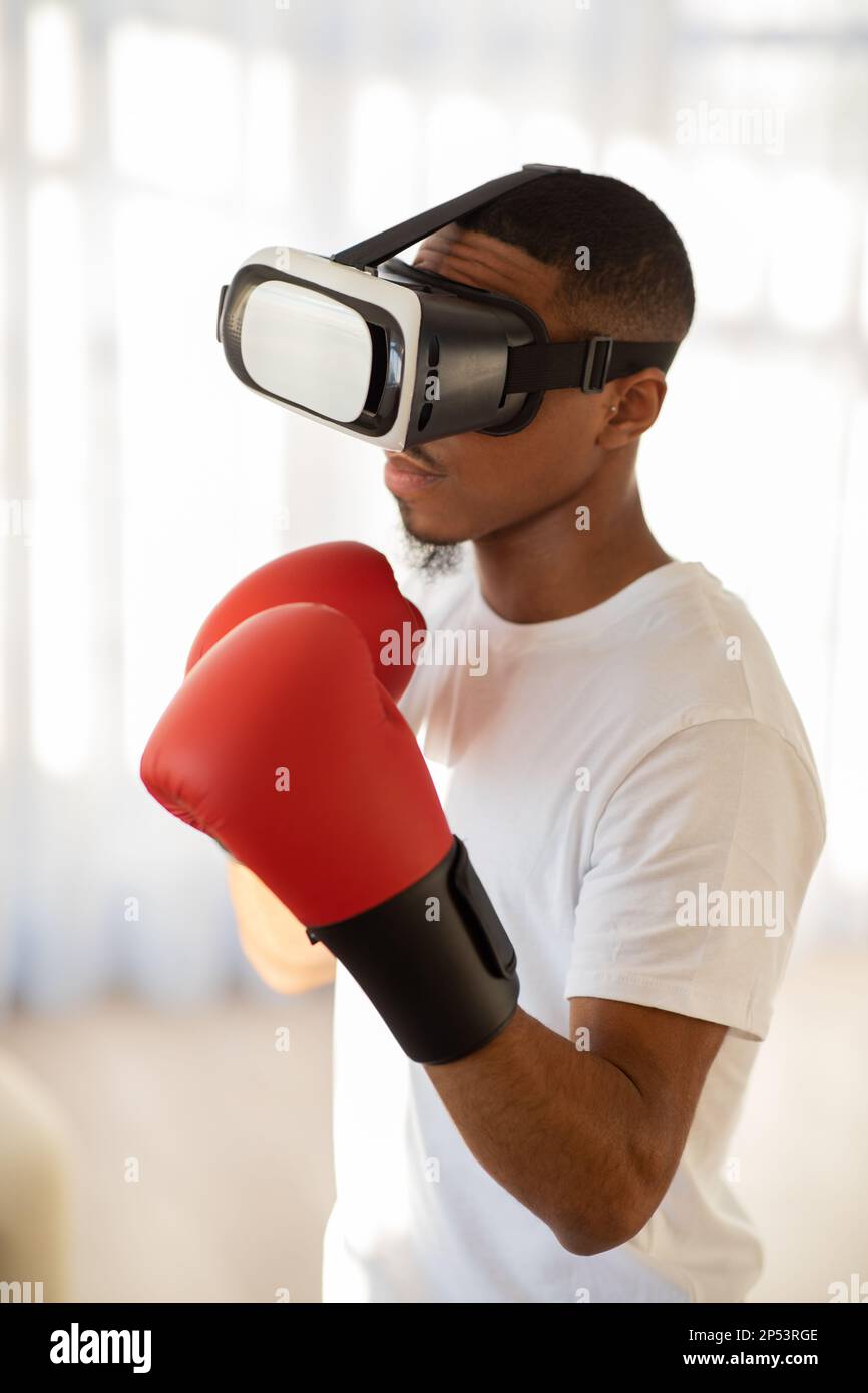 Portrait of black guy working out boxing in VR headset Stock Photo Alamy