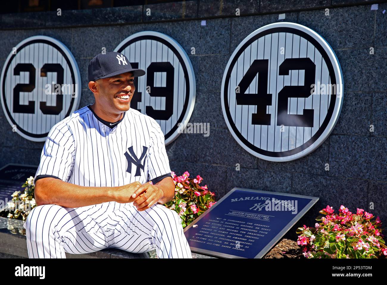 New York Yankees relief pitcher Mariano Rivera (42) poses with a plaque  showing his retired number in Monument Park during a pregame ceremony at  Yankees Stadium before a baseball game against the