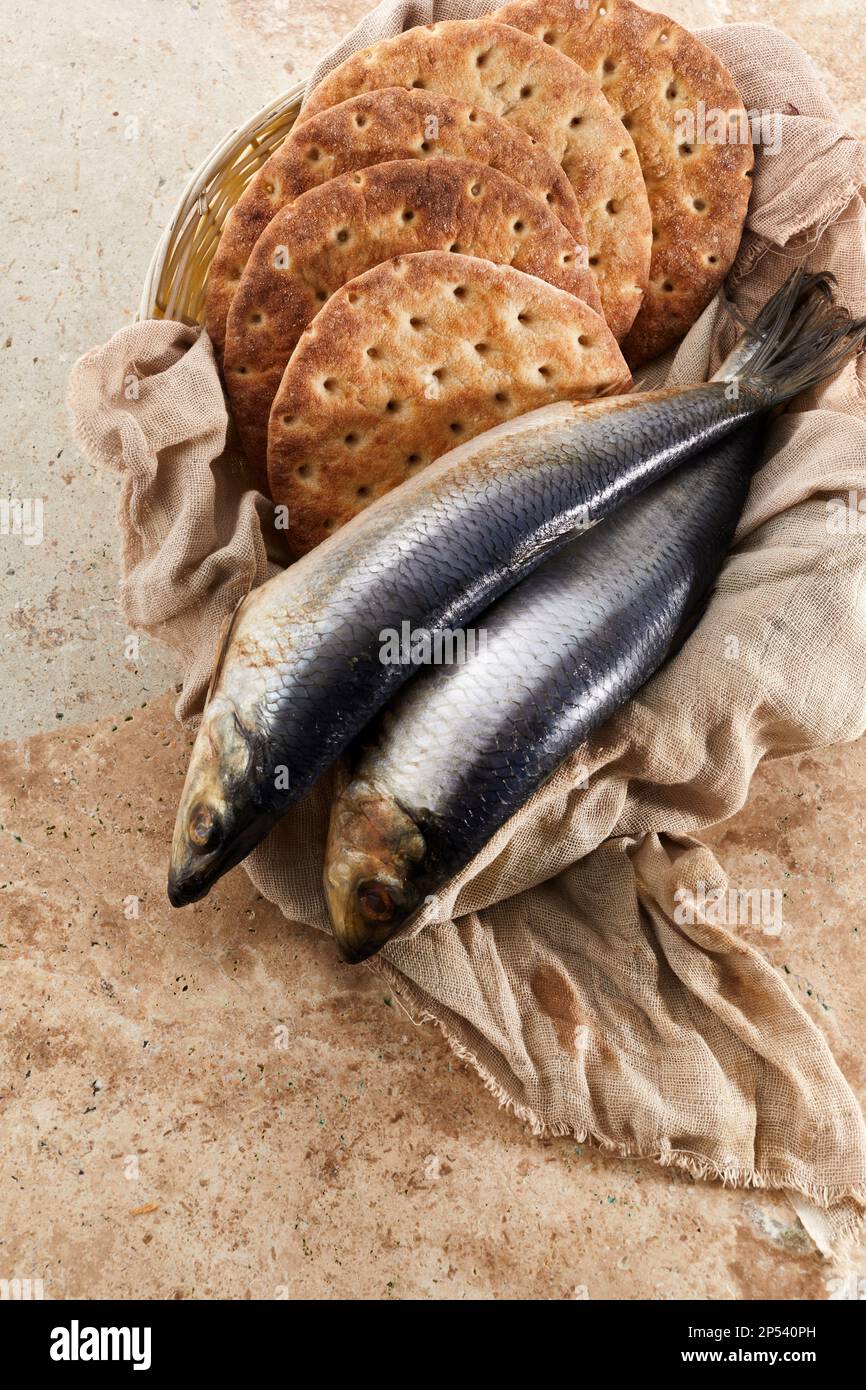 Catholic still life of five loaves of bread and two fish Stock Photo