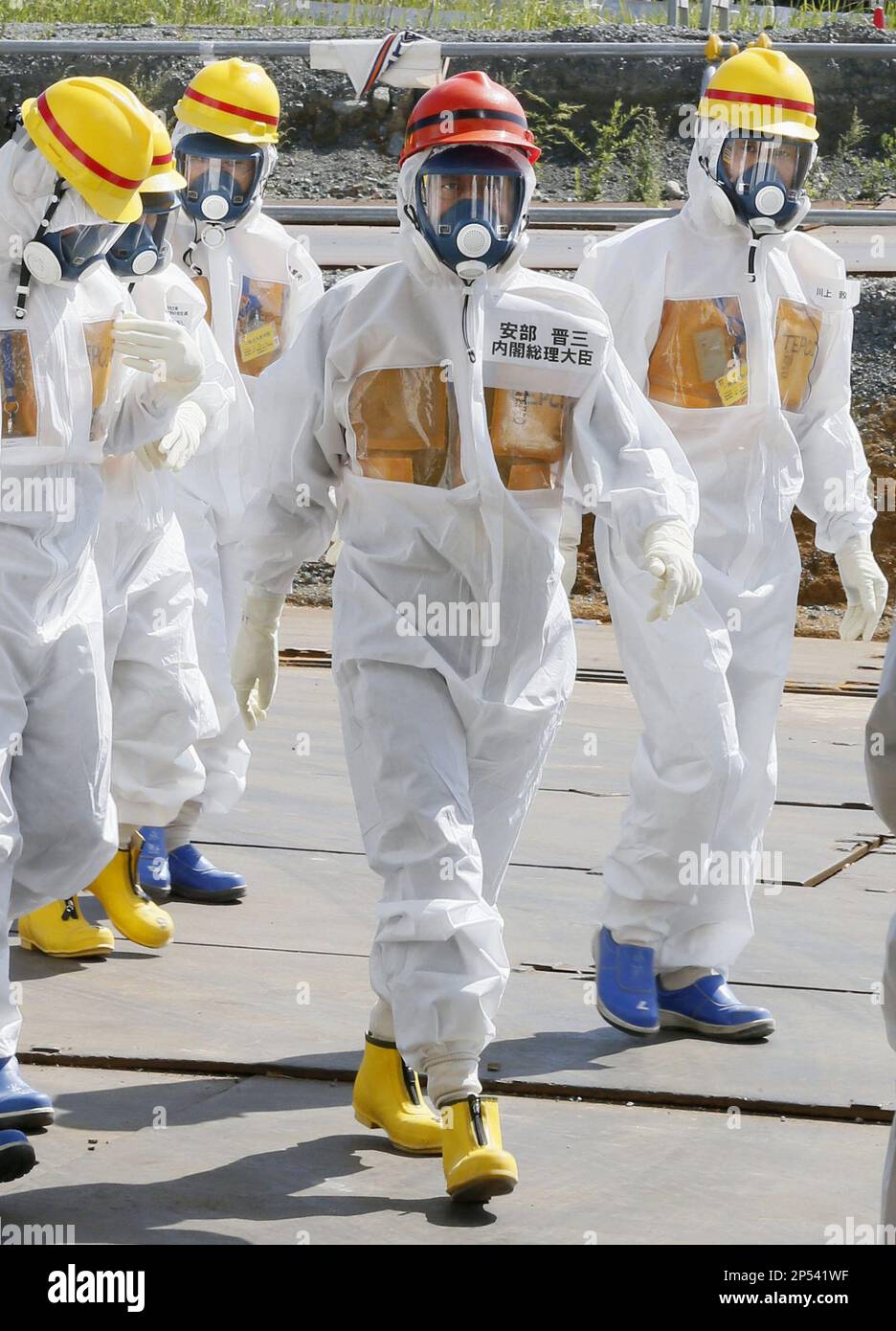 Japanese Prime Minister Shinzo Abe, center, arrives at a facility ...