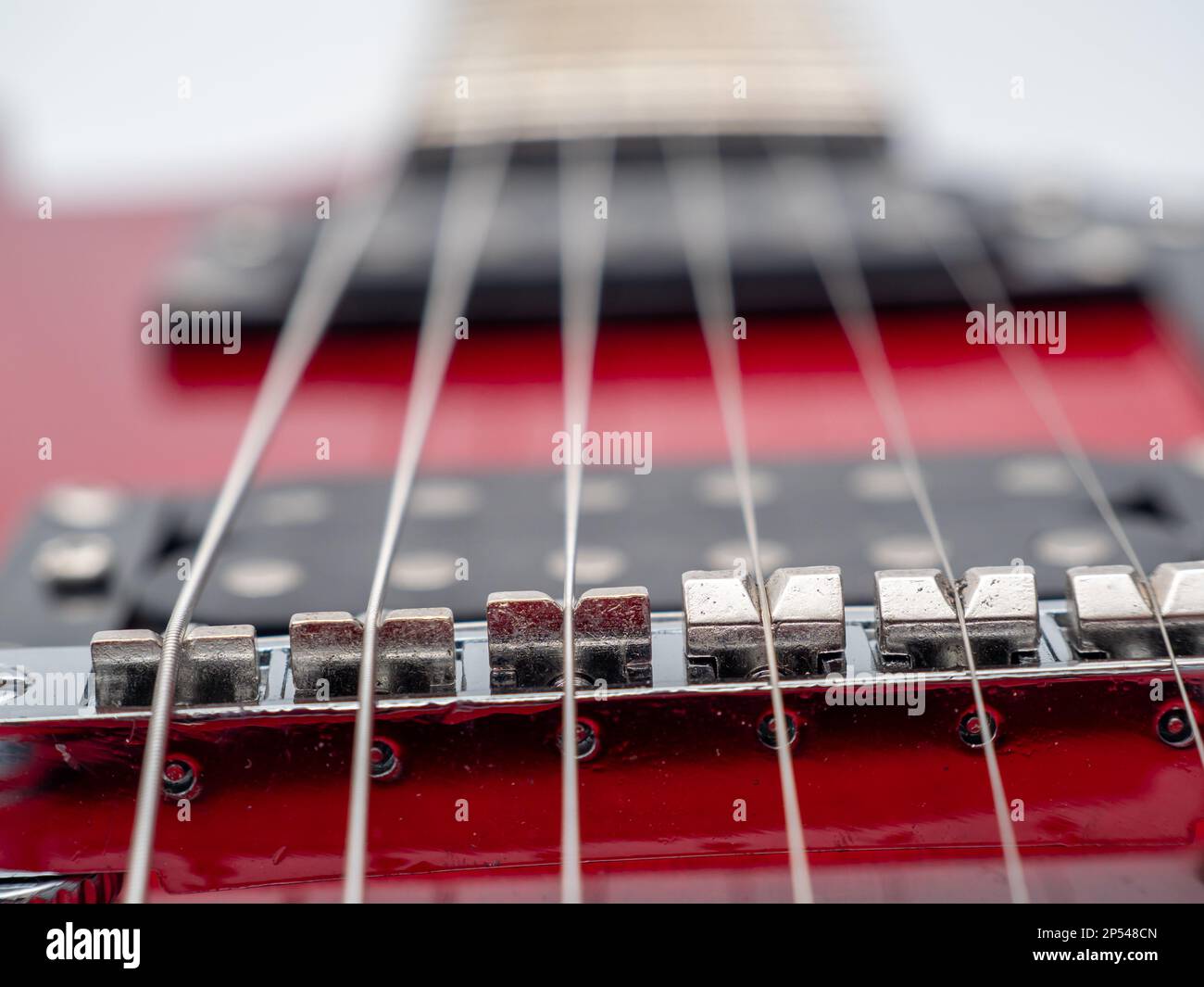 Red electric guitar isolated on white background. Musical instrument guitar. Close-up. Stock Photo