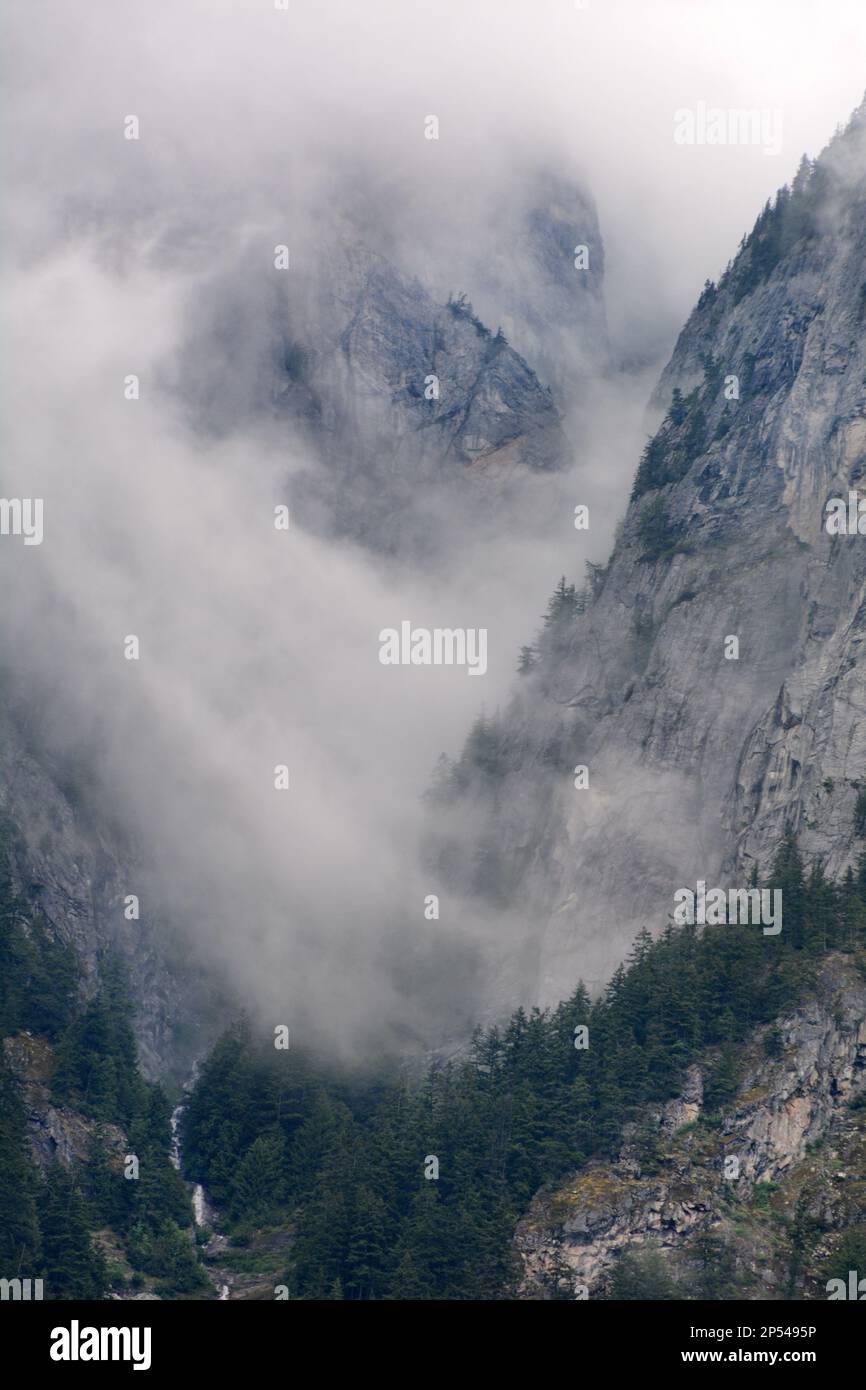 The misty rocky cliffs and slopes of Hope Mountain, in the Skagit Ranges of the North Cascade Mountain range, near Hope, British Columbia, Canada, Stock Photo