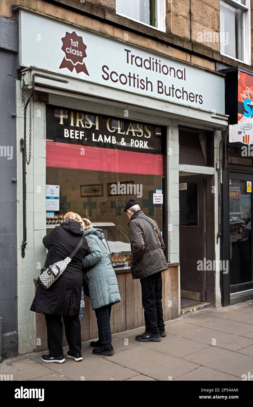 Customers looking in at the window of the Traditional Scottish Butchers shop in Newington, Edinburgh, Scotland, UK. Stock Photo