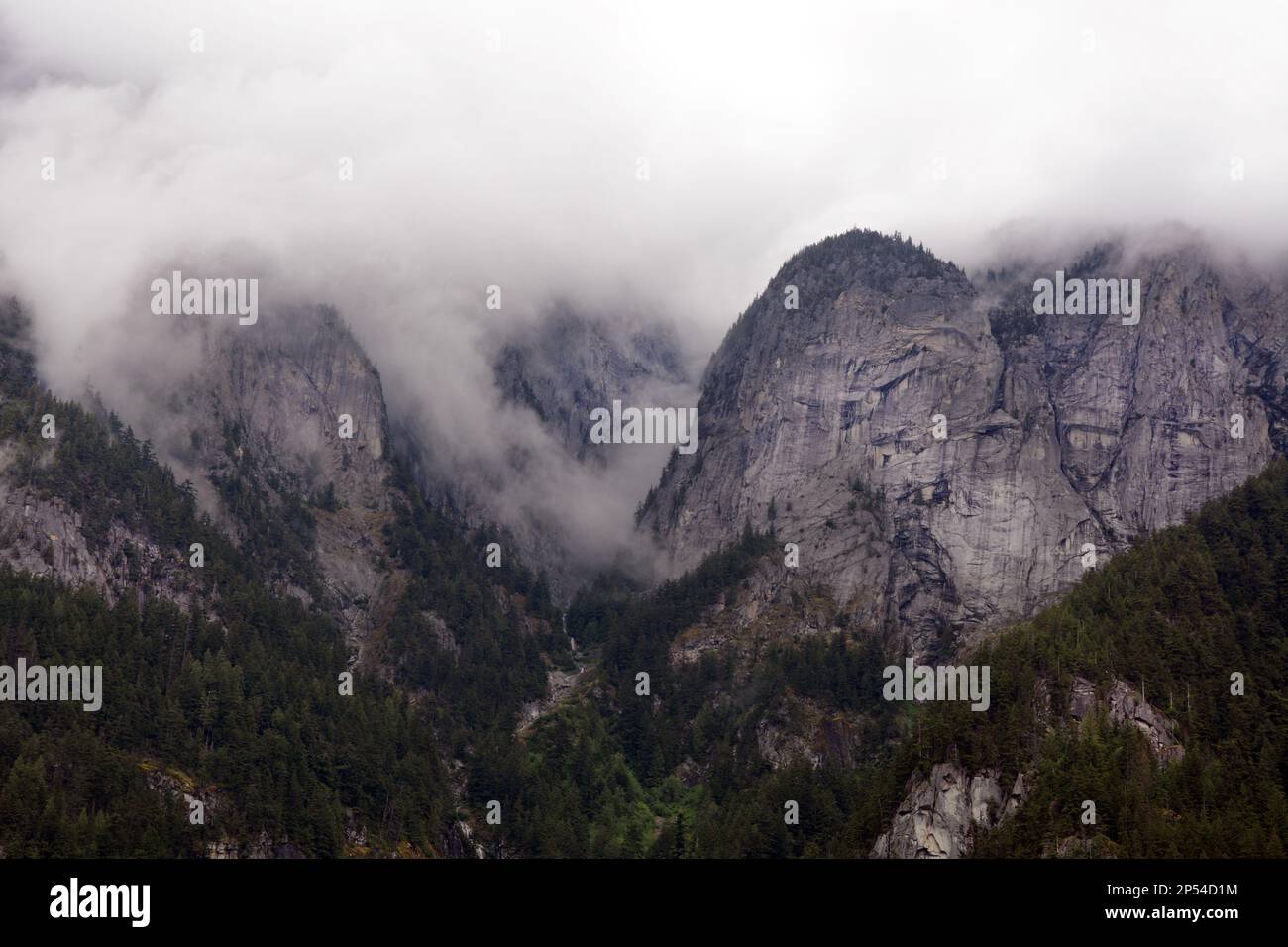 The misty rocky cliffs and slopes of Hope Mountain, in the Skagit Ranges of the North Cascade Mountain range, near Hope, British Columbia, Canada, Stock Photo