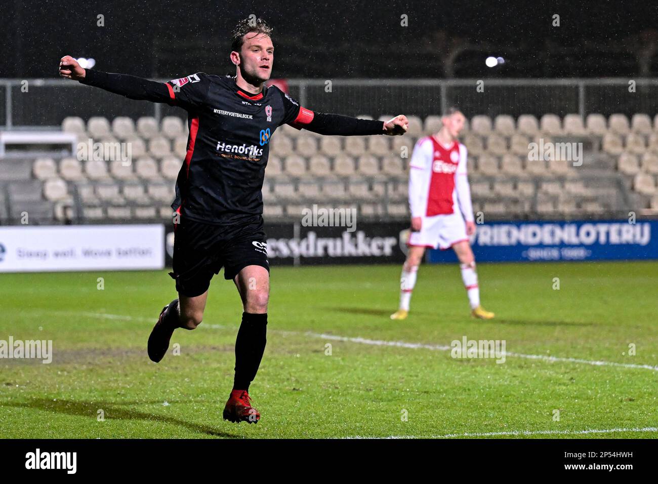 AMSTERDAM-DUIVENDRECHT, NETHERLANDS - MARCH 6: Rick Stuy van den Herik of  TOP Oss celebrates after scoring his teams first goal, Thijs van Leeuwen of  TOP Oss, Jearl Margaritha of TOP Oss during