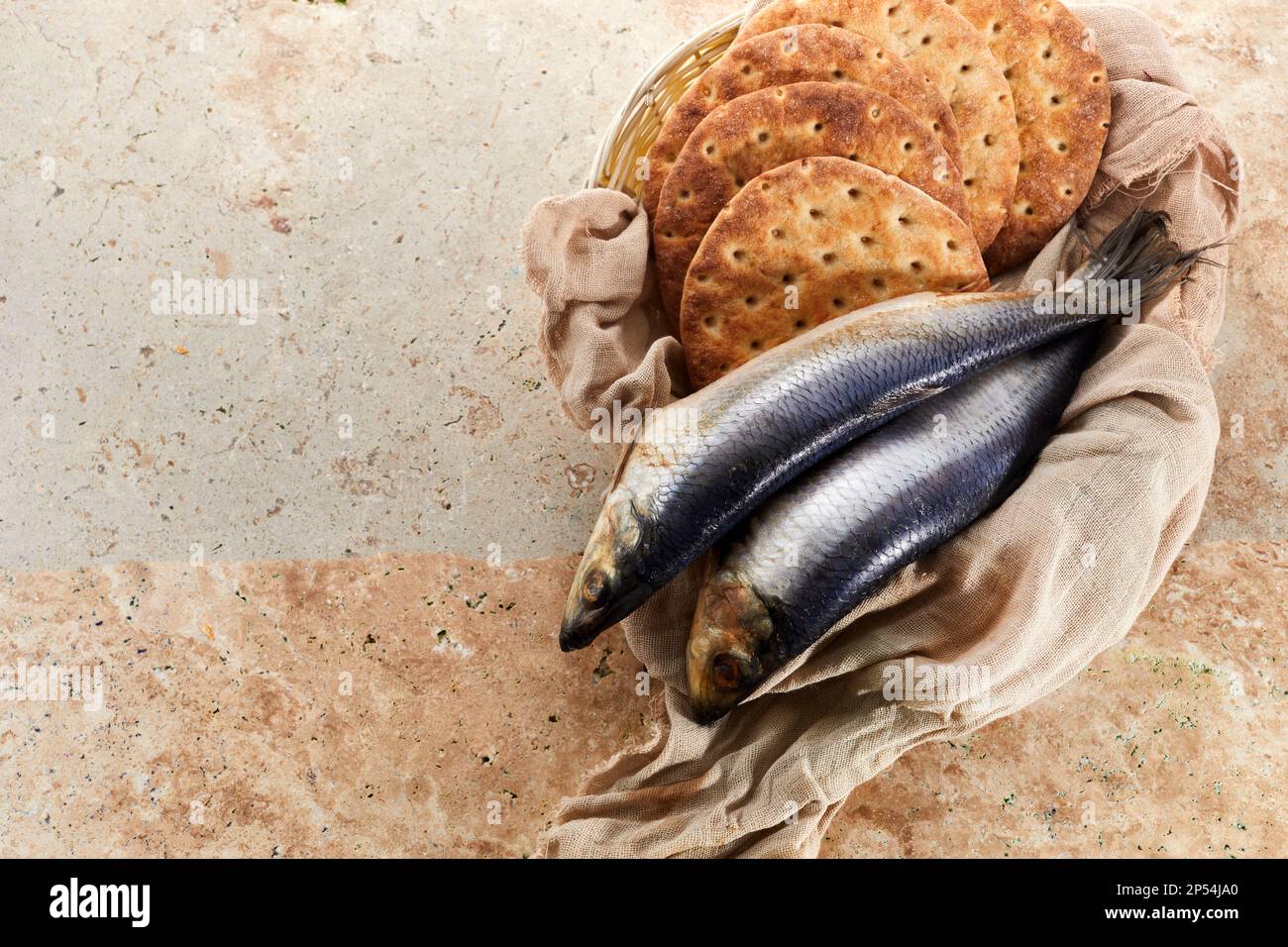 Catholic still life of five loaves of bread and two fish Stock Photo