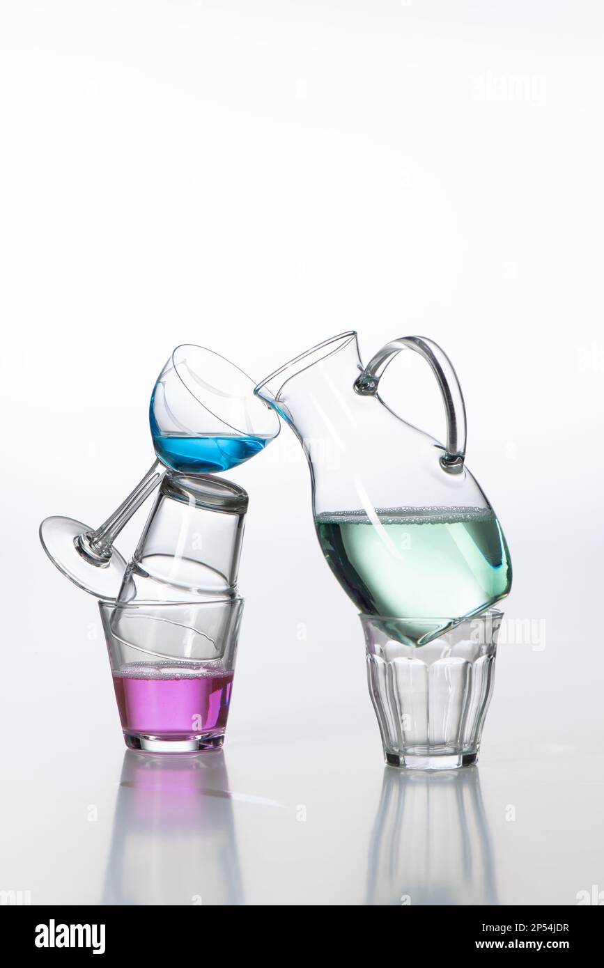 A still image from different shapes of glasses and vases, filled with colored water. Stock Photo