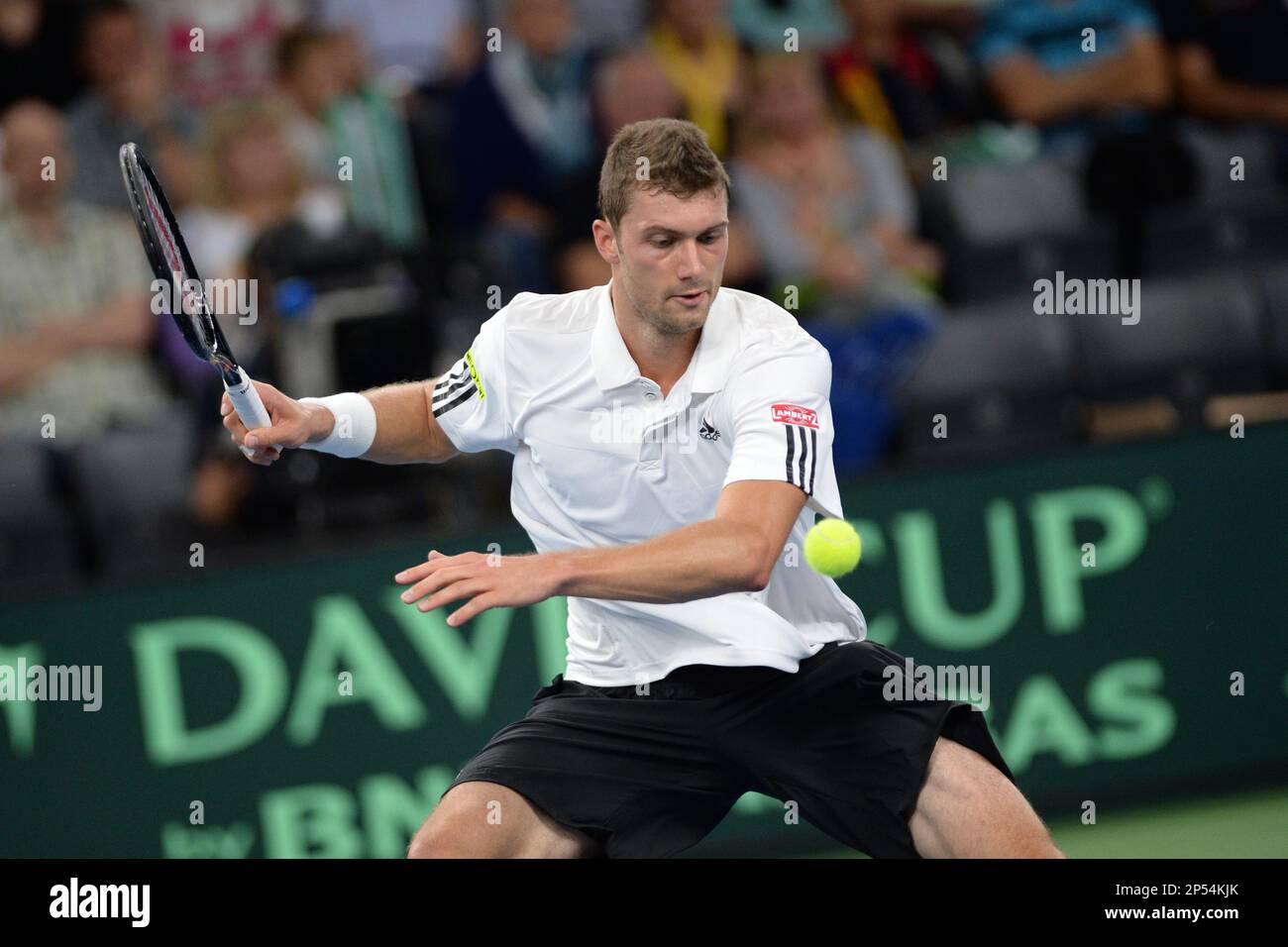 Germany's Daniel Brands returns a ball to Brazil's Thomaz Bellucci during  their third single match of the Tennis Davis Cup play-off round between  Germany and Brazil in Neu-Ulm, Germany Sunday Sept. 15,