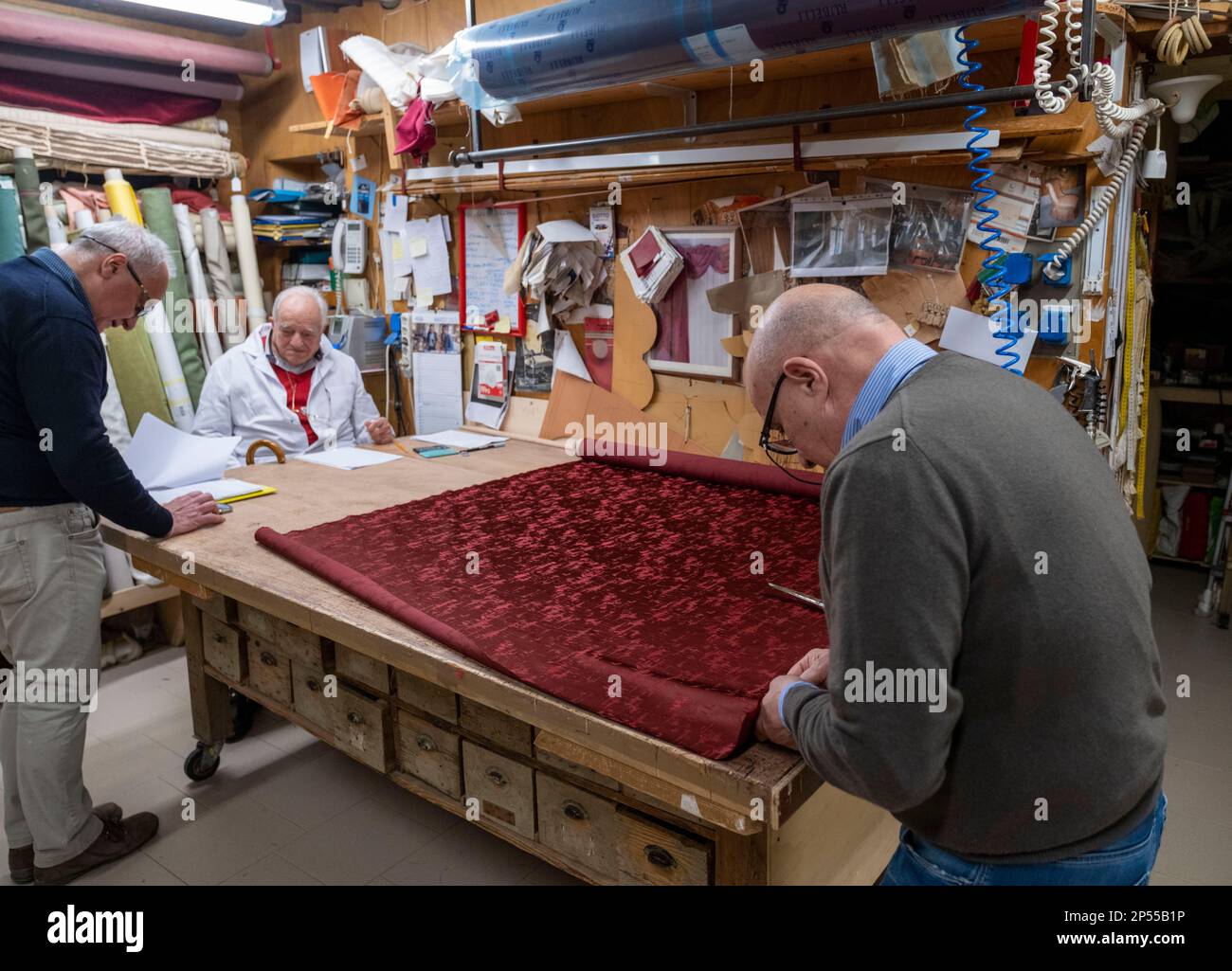 Upholsterers working in a shop in San Polo district, Venice, Italy. Stock Photo