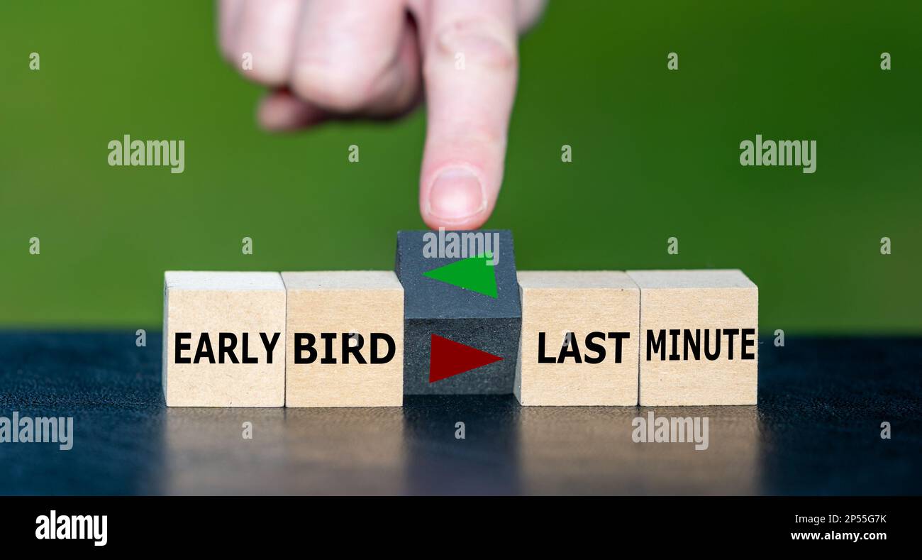 Hand turns cube and changes the direction of an arrow. Arrow points to the expression 'early bird' instead of 'last minute'. Stock Photo