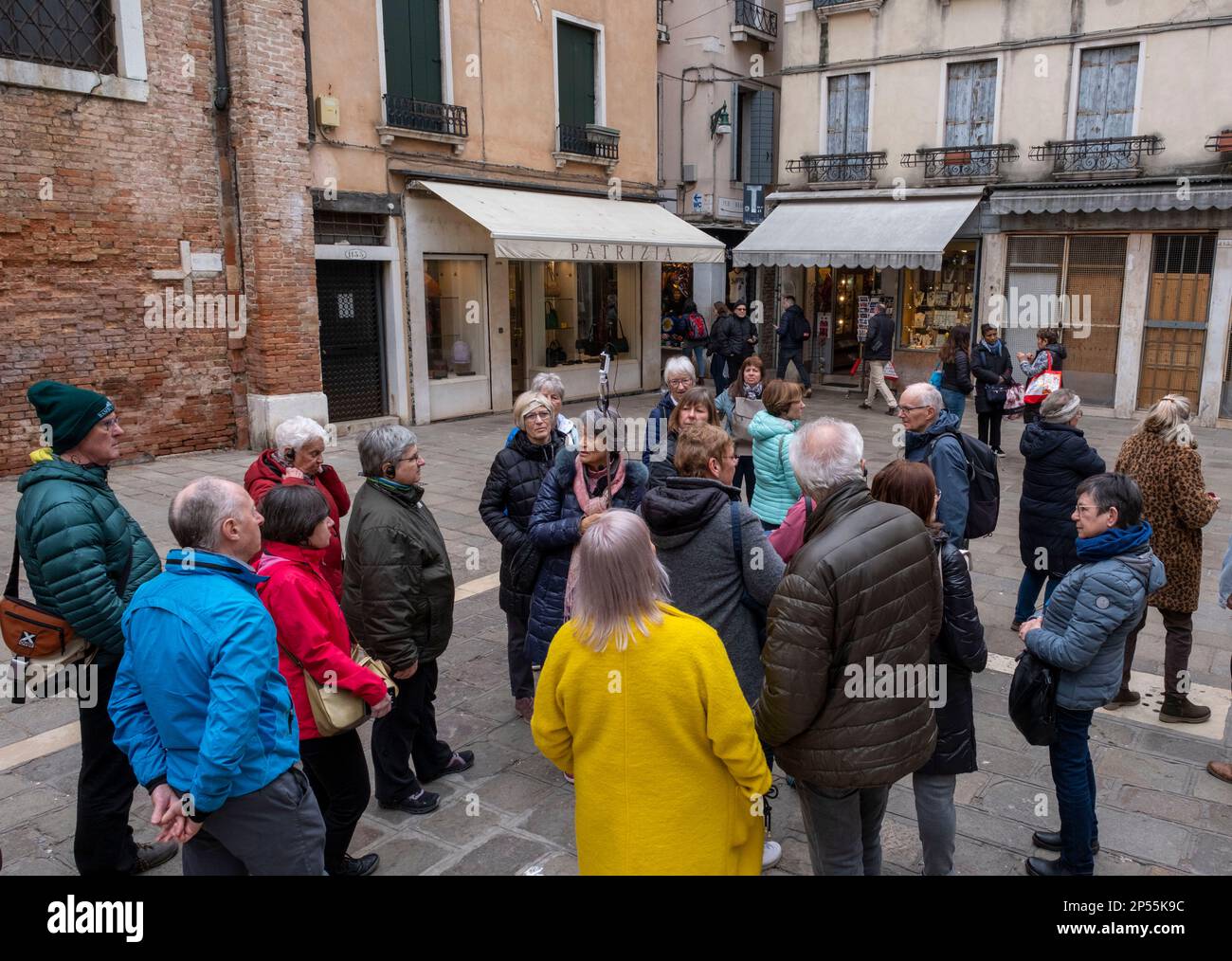 Travel guide gives a conducted tour in the San Polo district, Venice, Italy. Stock Photo