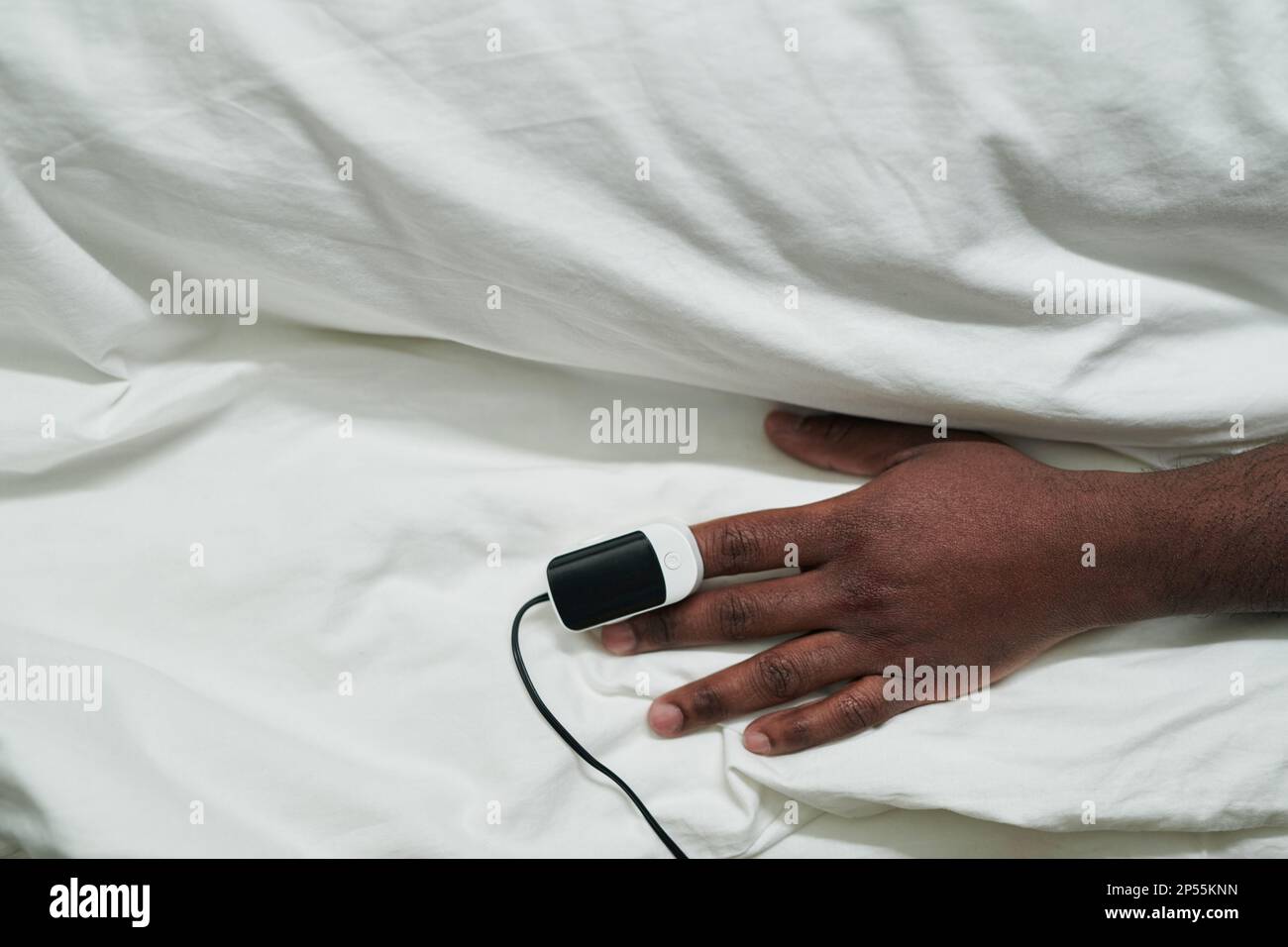 Hand of young African American male patient with pulse oximeter on