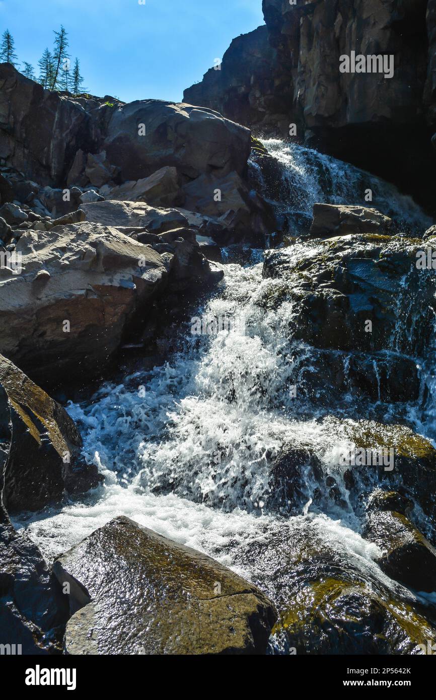 Putorana Plateau, a waterfall on the Grayling Stream. Mountain stream on a  cloudy day Stock Photo - Alamy