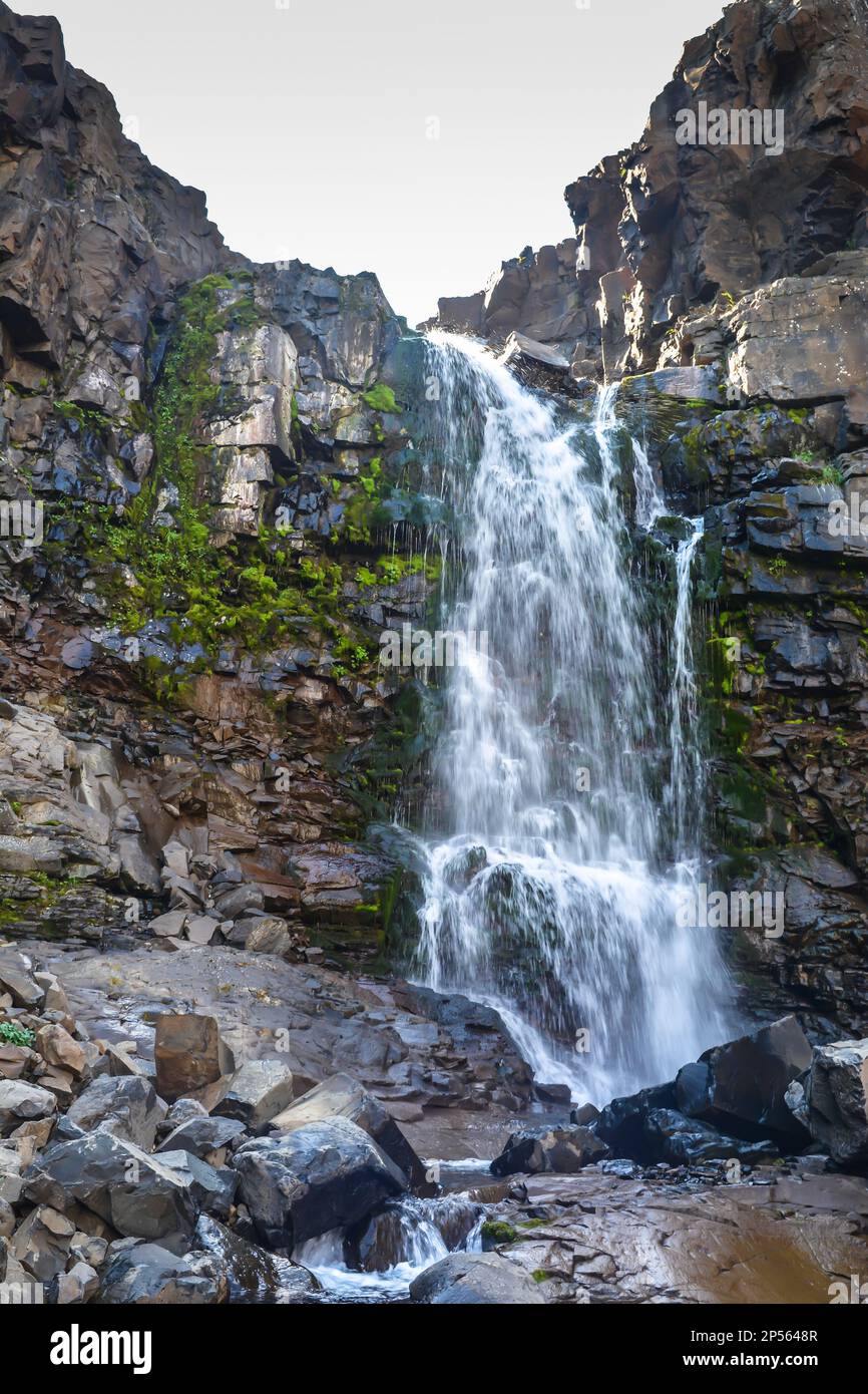 Putorana Plateau, a waterfall on the Grayling Stream. Mountain stream on a  cloudy day Stock Photo - Alamy