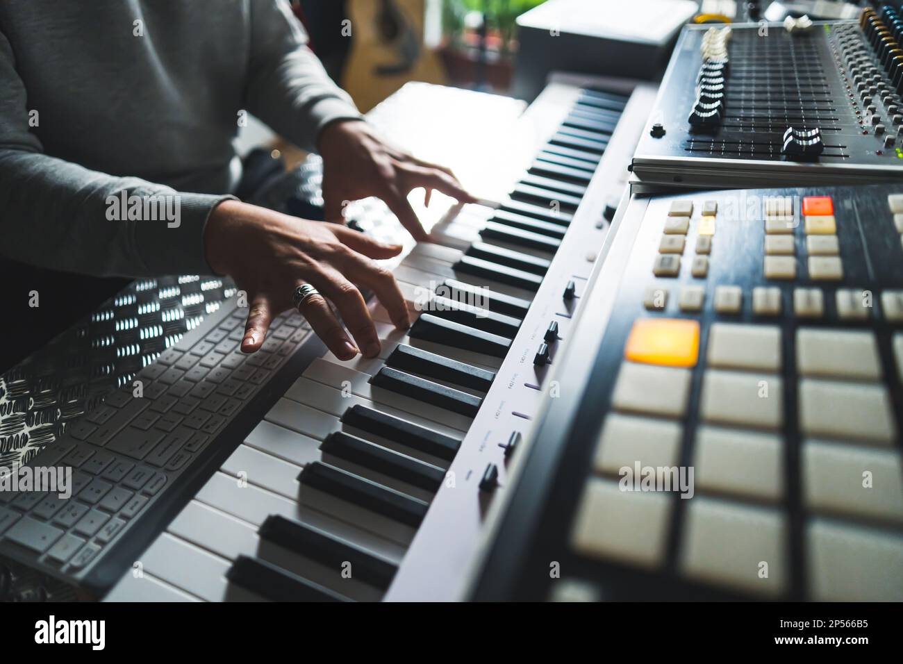 closeup shot of an unknown man playing the electronic piano, home studio.  High quality photo Stock Photo - Alamy