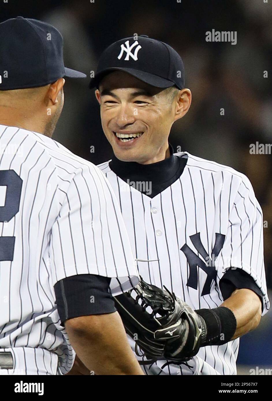 New York Yankees' Ichiro Suzuki (R) is congratulated by his