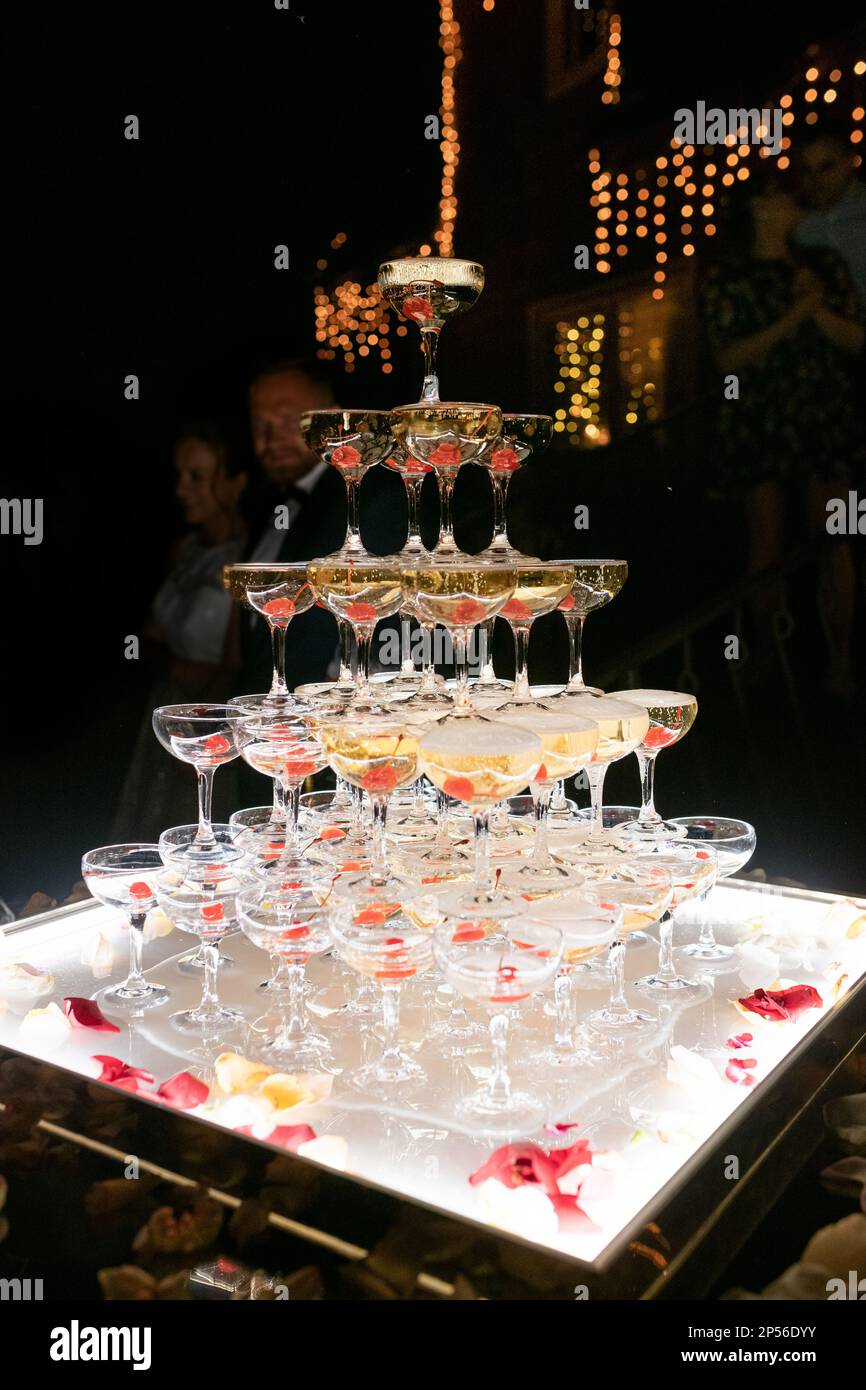 Champagne glasses standing in a tower at the wedding party. Champagne