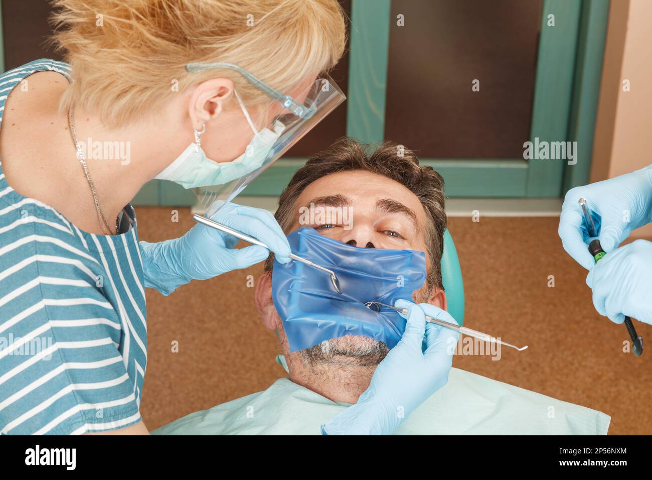 Patient at the dentist with a rubber dam Stock Photo Alamy