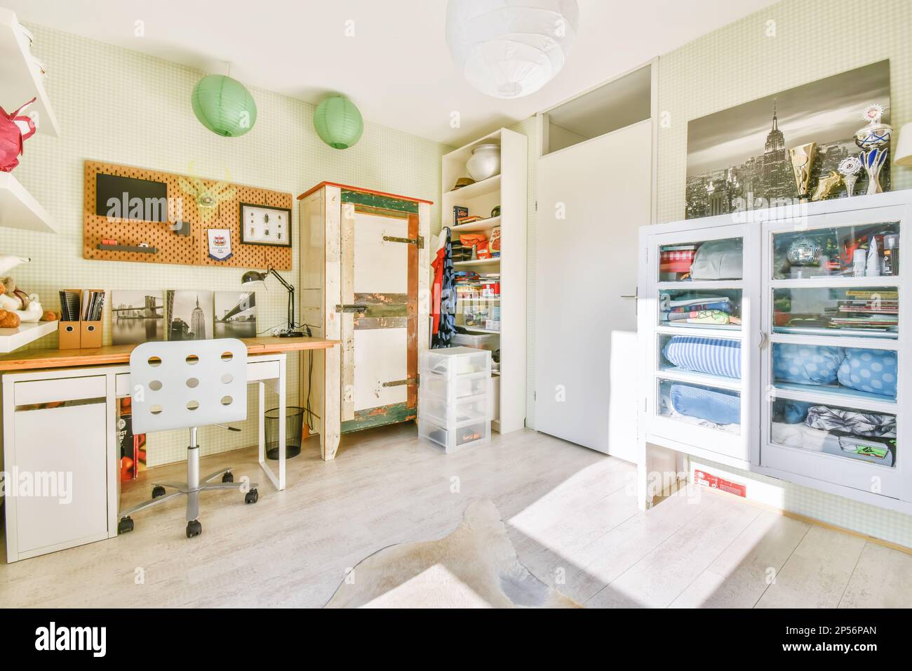 Amsterdam, Netherlands - 10 April, 2021: a kitchen with lots of stuff on the counters and shelves in front of the refrigerator freezer is white Stock Photo