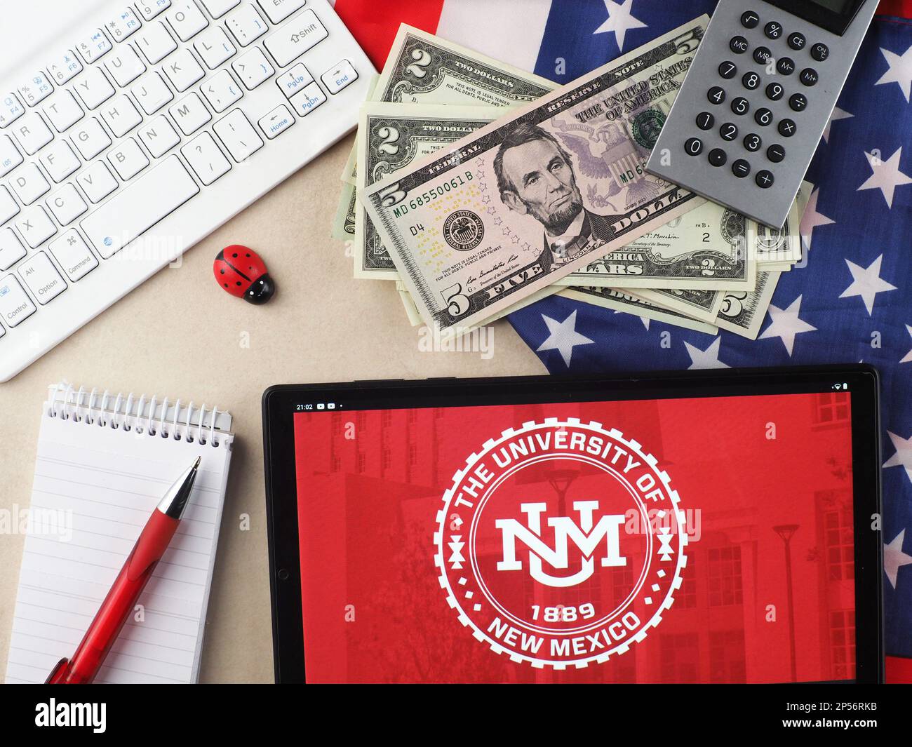 In this photo illustration, Washington State University, University of New Mexico  logo seen displayed on a tablet. Stock Photo