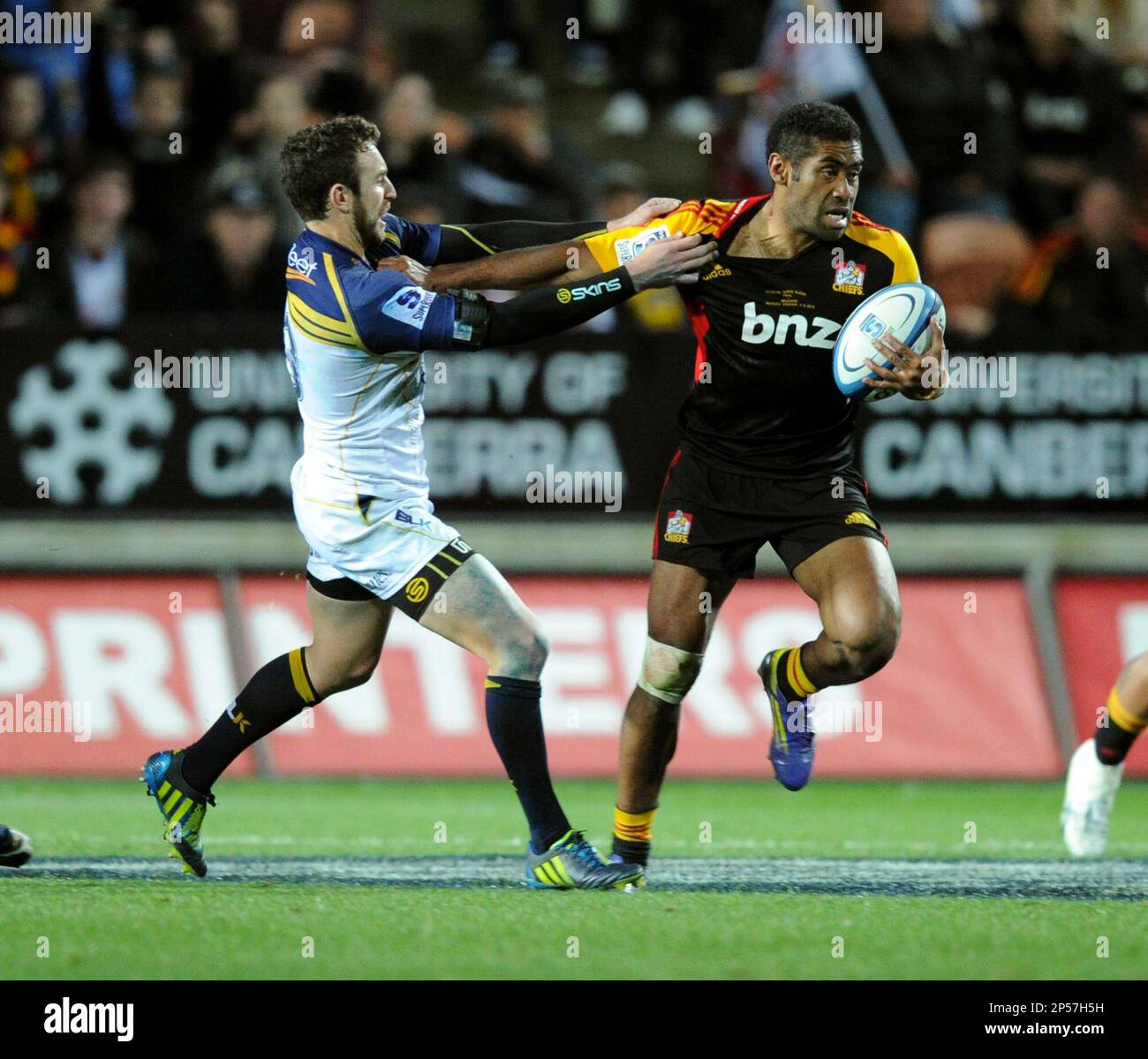 Chiefs' Asaeli Tikoirotuma, right, fends off the Brumbies' Nic White in the Super  Rugby final match