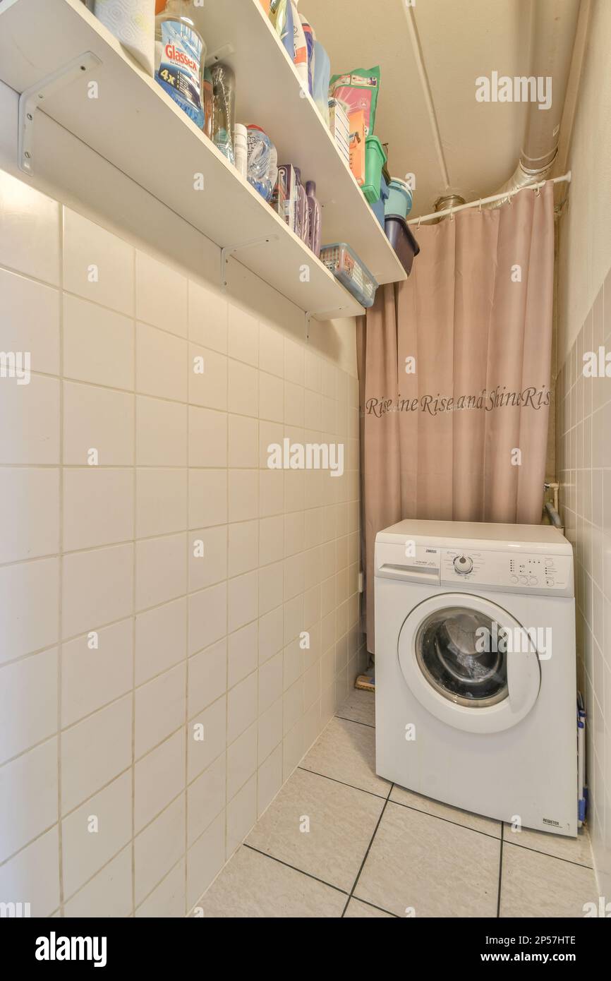 a laundry room with a washer and dryer on the wall, in front of an open ...