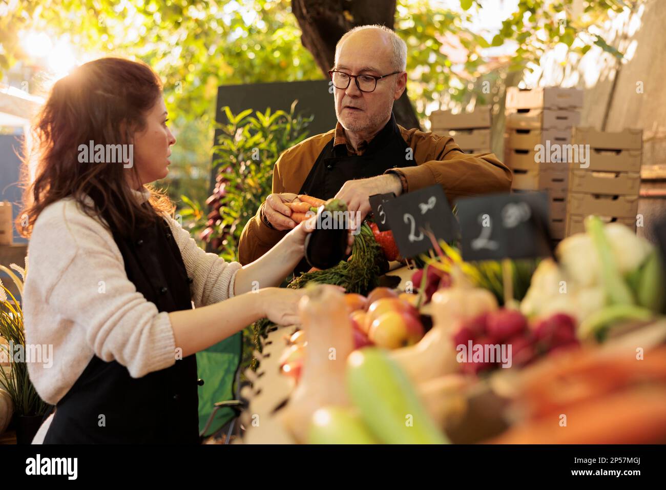 Family couple of farmers putting farm fresh organic fruits and ...