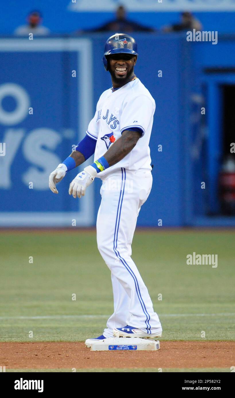 Toronto Blue Jays' Jose Reyes laughs toward the bench after hitting a  double against the Houston Astros during the first inning of a baseball  game, Friday, July 26, 2013, in Toronto. (AP