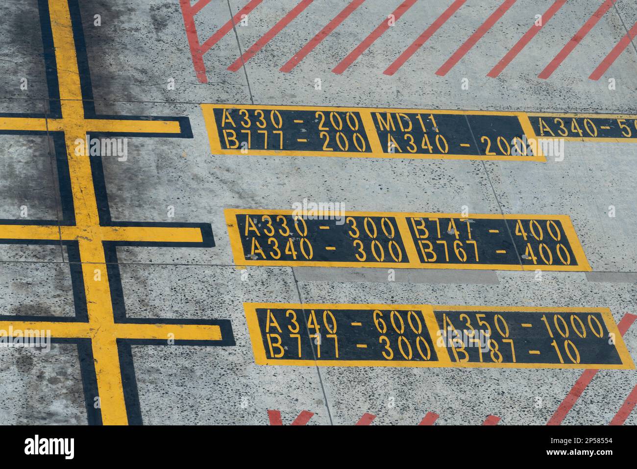 Cape Town, South Africa. 2023. Airport hatching lines with aircraft types and numbers painted on the aircraft parking zone. Stock Photo
