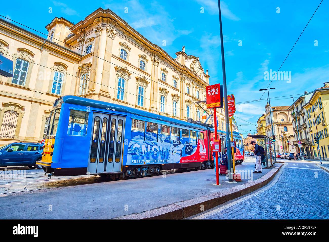 MILAN, ITALY - APRIL 11, 2022: Colorful tram on the tram stop on Corso Magenta street, on April 11 in Milan, Italy Stock Photo